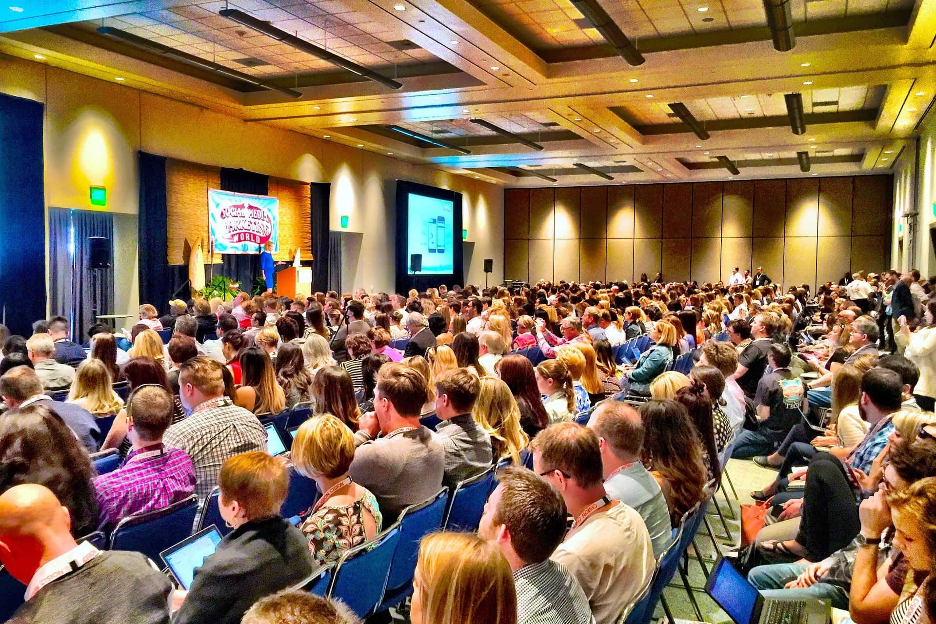 Bloggers attending a blogging conference, watching a speaker give a presentation.