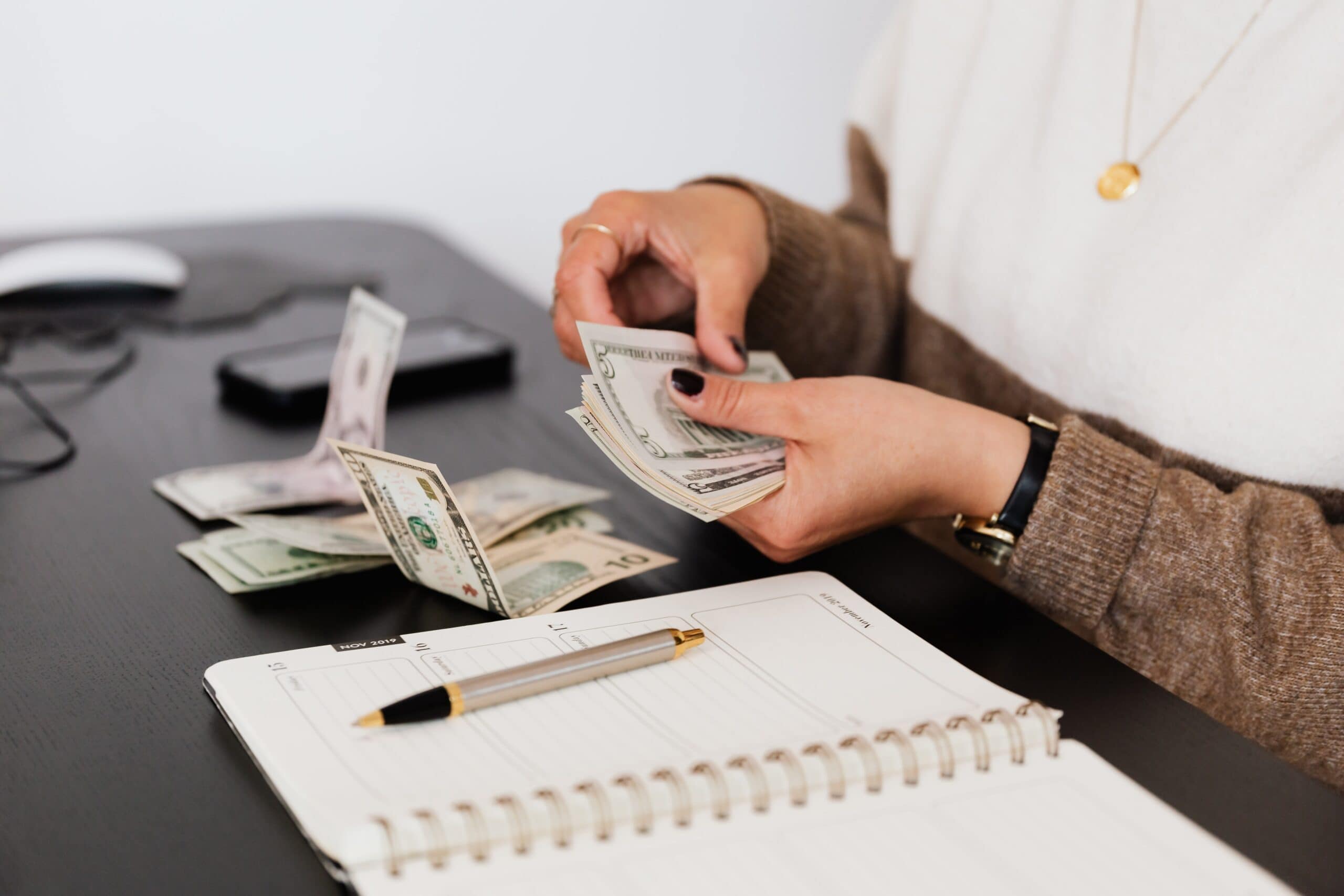 Woman's hands counting out bank notes