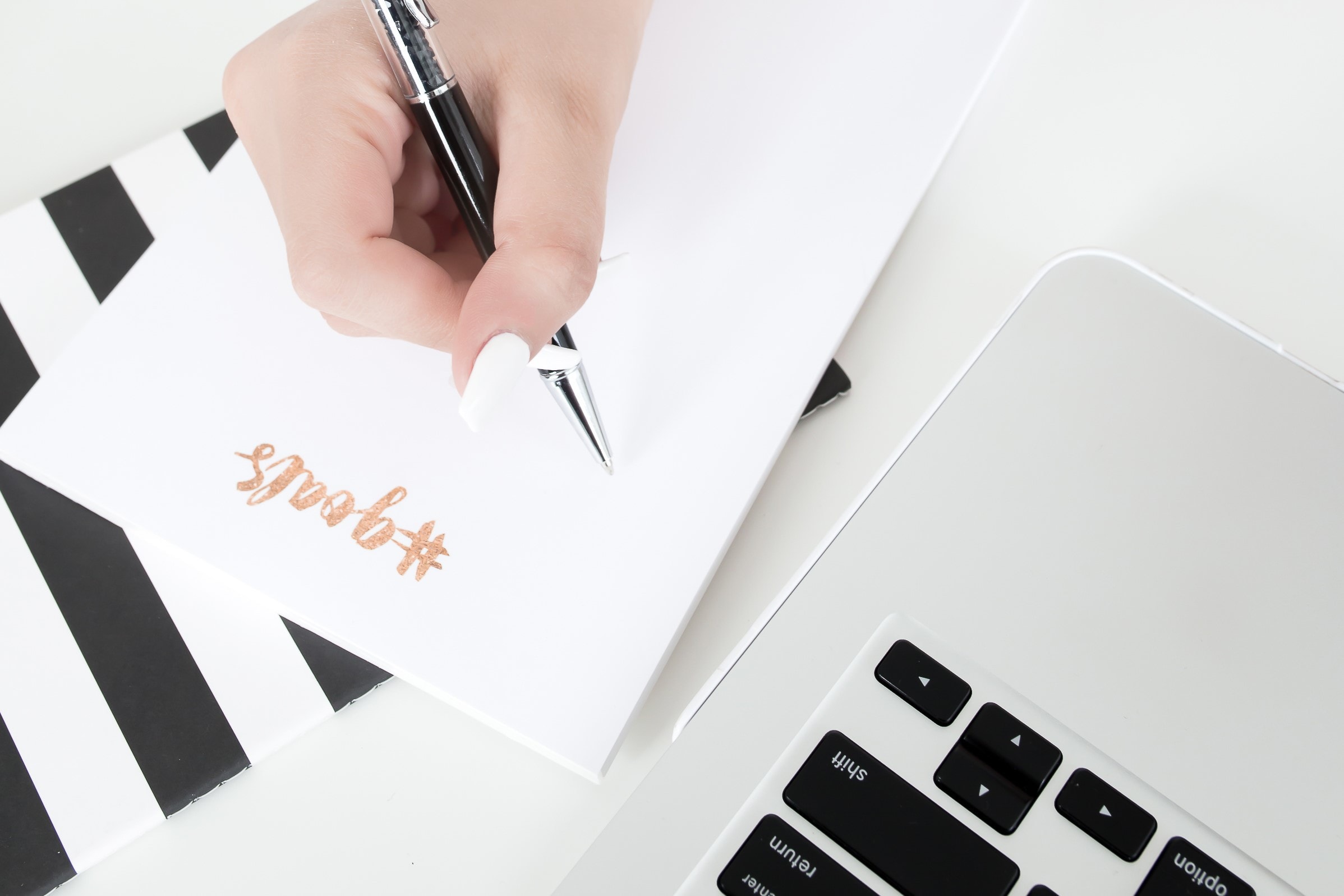 Overhead of woman writing on a notepad