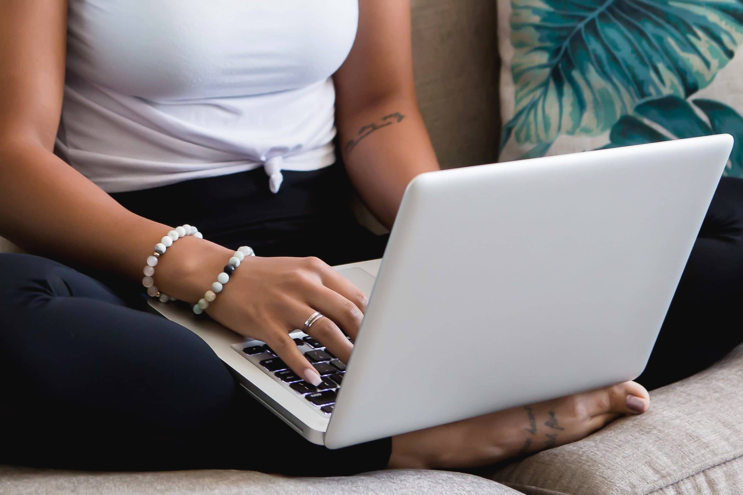 Lady sitting on a sofa typing