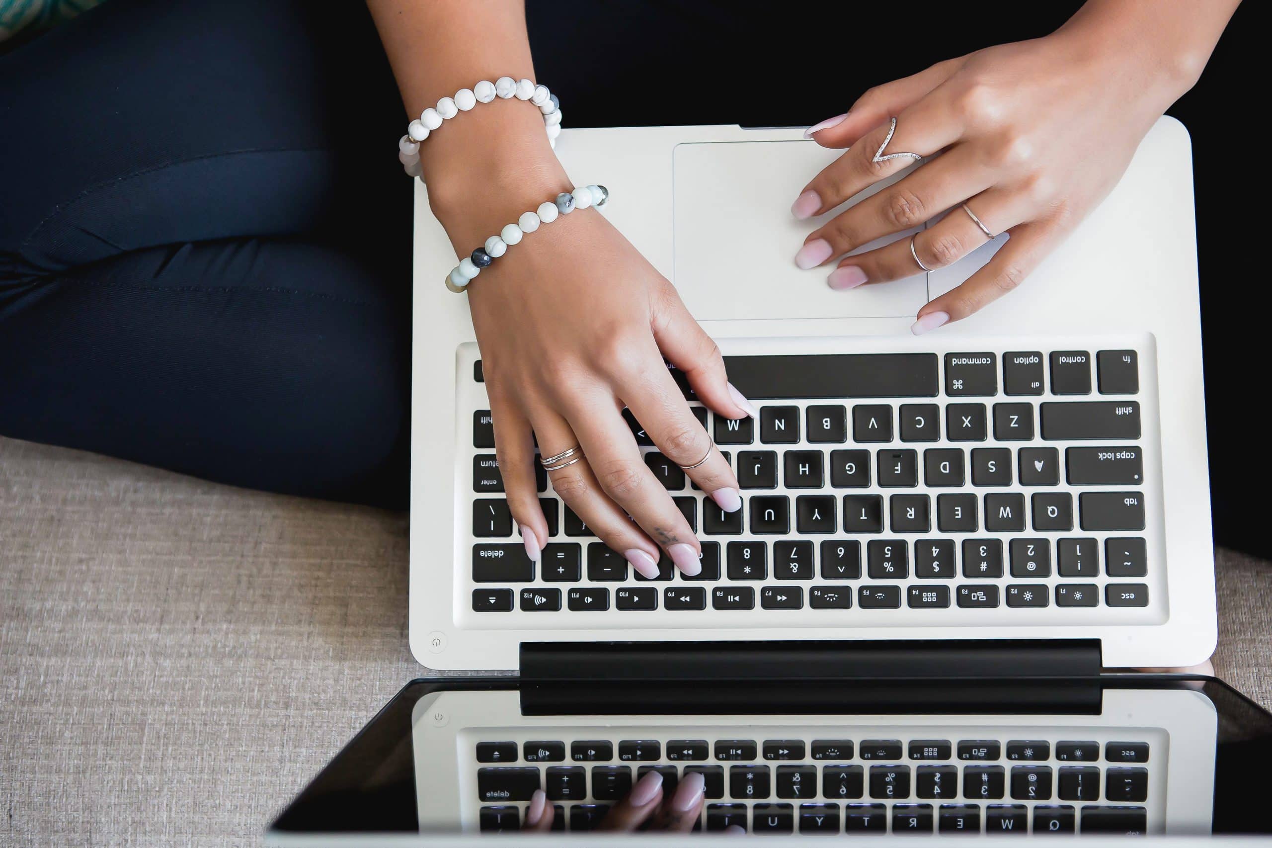 Overhead of lady typing at a laptop