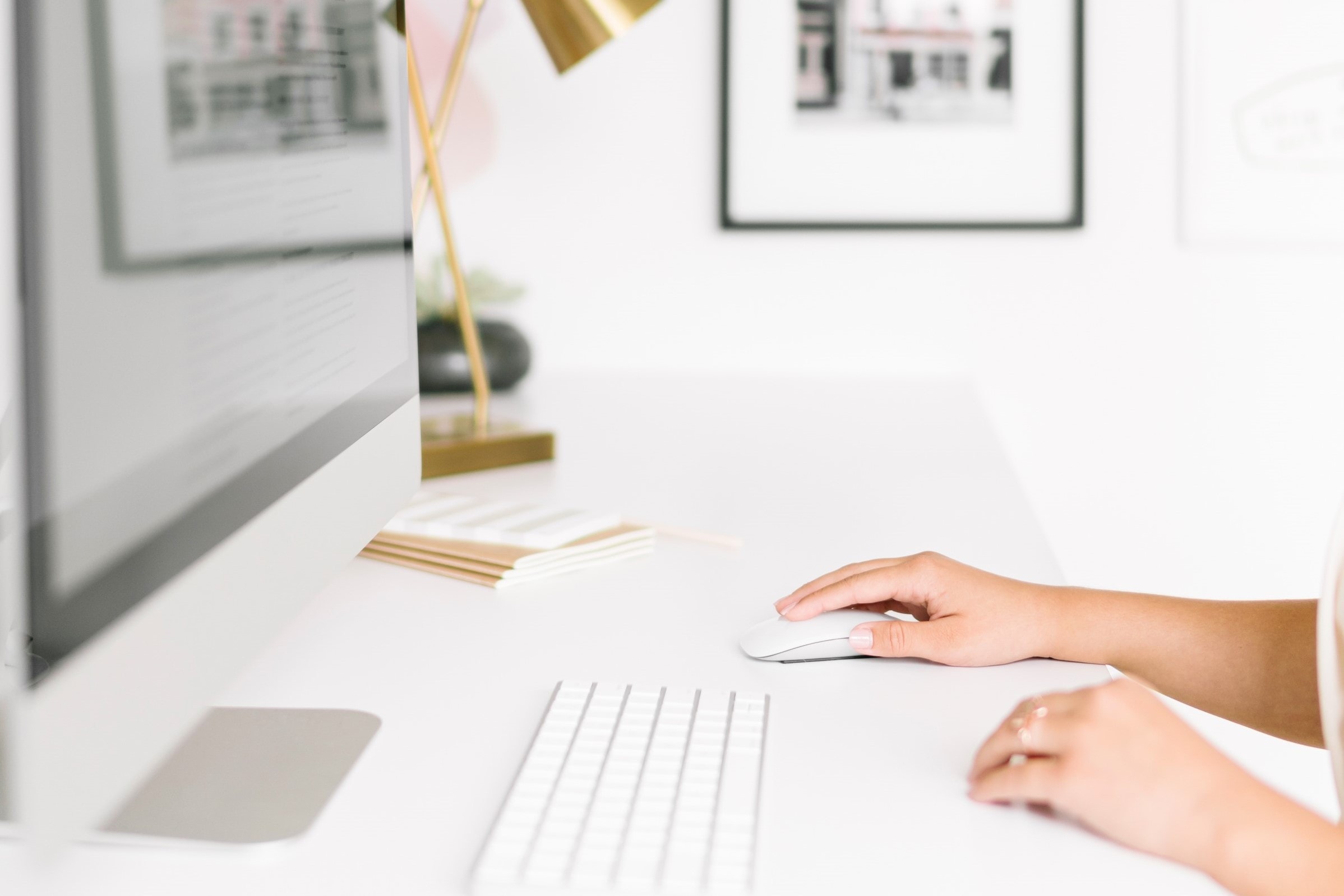 Woman using a mouse at a computer