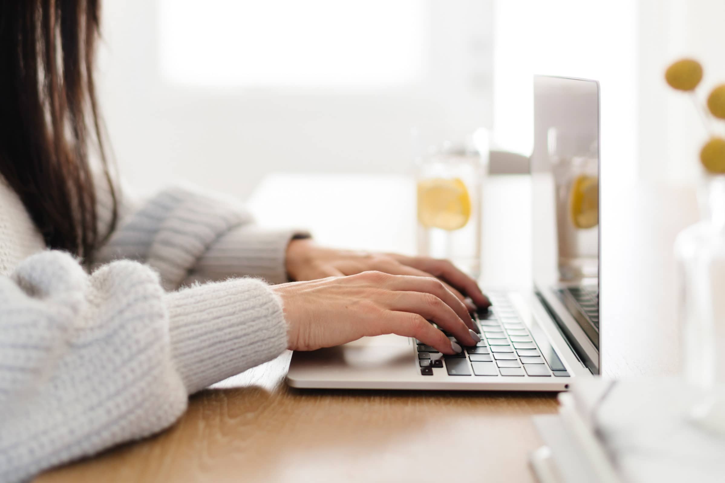 Woman typing on a laptop